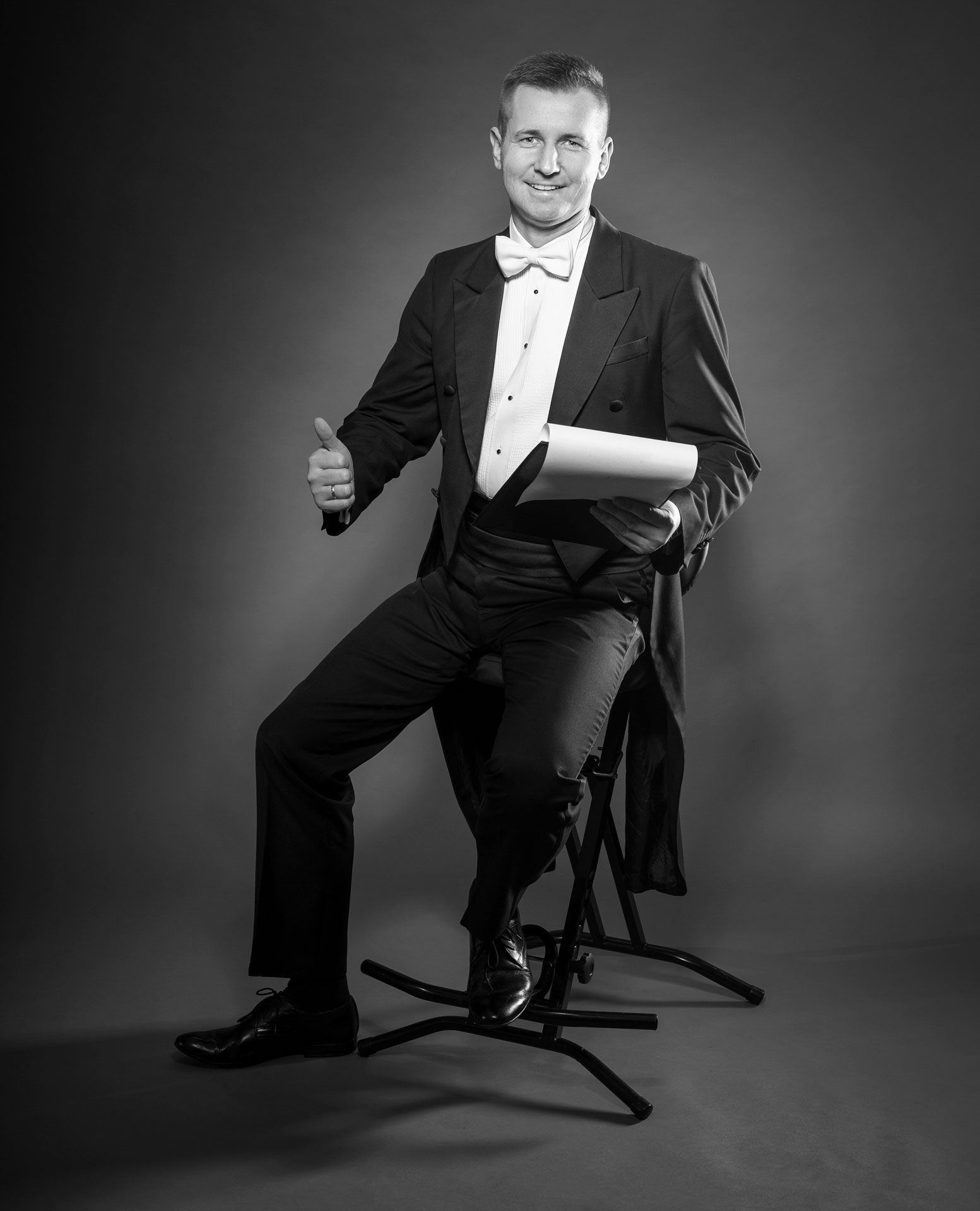 Wodzirej Karpik we fraku i z przygotowanymi ustaleniami na papierze odnośnie prowadzenia wesela